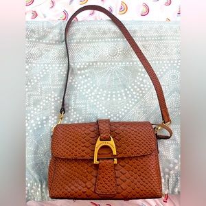 Dooney and Bourke clutch with shoulder strap and dust bag. Excellent condition.